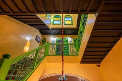 a room with green and yellow stairs and windows at Riad Marrakech 88 Retro Chic 3 Rooms with Shared Pool in Marrakech