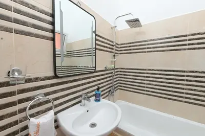 a bathroom with a sink and a mirror and a tub at Riad Marrakech Golden Star 82 with 3 Rooms & Pool in Marrakech