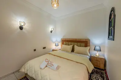 a bedroom with a bed with two towels on it at Riad Marrakech Golden Star 82 with 3 Rooms & Pool in Marrakech