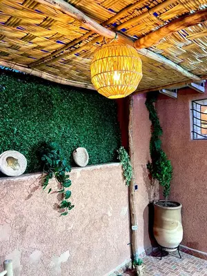a patio with plants and a ceiling with a light at Adomar Lighted Terrace Retreat, 2BR Comfort in Marrakech