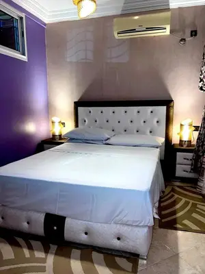 a large white bed in a bedroom with two lamps at Adomar Lighted Terrace Retreat, 2BR Comfort in Marrakech
