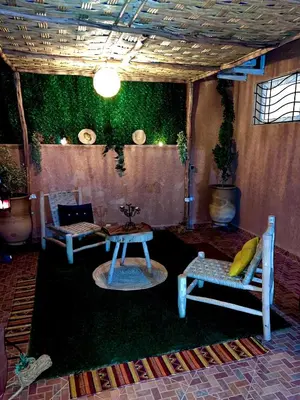 a living room with a table and a couch and a table and chairs at Adomar Lighted Terrace Retreat, 2BR Comfort in Marrakech