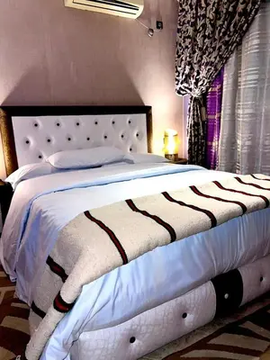 a bedroom with a large bed with a white bedspread at Adomar Lighted Terrace Retreat, 2BR Comfort in Marrakech