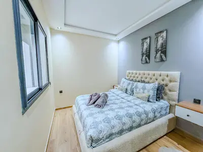 a bedroom with a bed and a window at Modern Studio Menara Garden in Marrakech