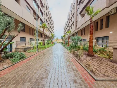 a cobblestone street in a building with palm trees at Modern Studio Menara Garden in Marrakech