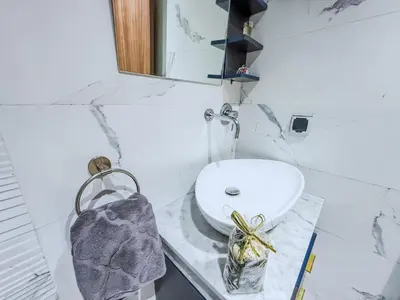 a white bathroom with a sink and a mirror at Modern Studio Menara Garden in Marrakech