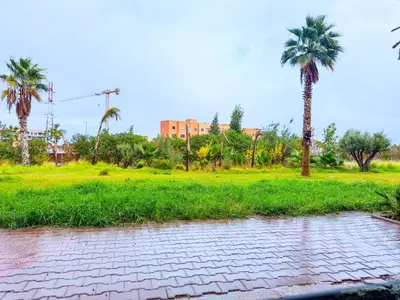 a park with palm trees and a brick road at Modern Studio Menara Garden in Marrakech