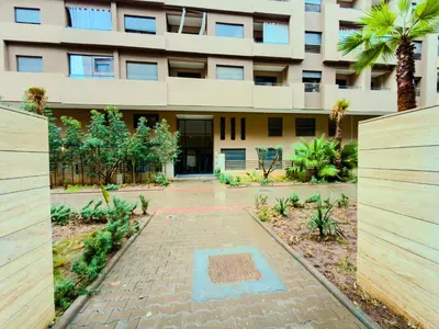 a building with a brick driveway in front of a building at Modern Studio Menara Garden in Marrakech
