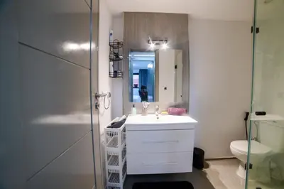 a bathroom with a sink and a mirror and a shower at Appartemment top Marrakech in Marrakech