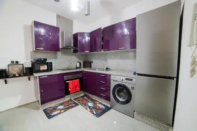 a kitchen with purple cabinets and a washing machine at Appartemment top Marrakech in Marrakech