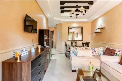 a living room with a couch and a table at Appartement marrakech garden in Marrakech