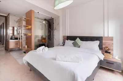 a bedroom with a large bed with white sheets at 3 BED Hidden Gem Self Check-in With Pool M6 BLVD in Marrakech