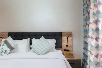 a bedroom with a bed with white sheets and pillows at 3 BED Hidden Gem Self Check-in With Pool M6 BLVD in Marrakech