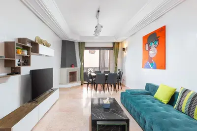 a living room with a blue couch and a table at 3 BED Hidden Gem Self Check-in With Pool M6 BLVD in Marrakech