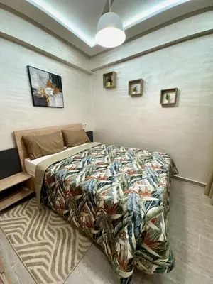 a bedroom with a bed with a colorful comforter at Gueliz Bright & Modern 2BR 2 Balcons in Marrakech
