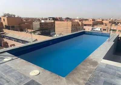 a large swimming pool on the roof of a building at Écrin Cosy au Cœur de Guéliz Emplacement Central in Marrakech