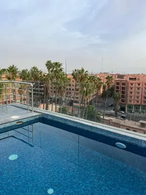 a large swimming pool on top of a building at Écrin Cosy au Cœur de Guéliz Emplacement Central in Marrakech