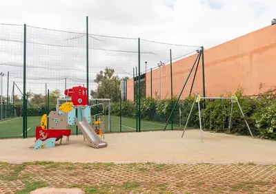 a playground with a slide and a swing set at Noria Golf Marrakech Pool in Marrakech
