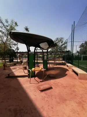 a park with a bus stop with a bench and a bus at Noria Golf Marrakech Pool in Marrakech