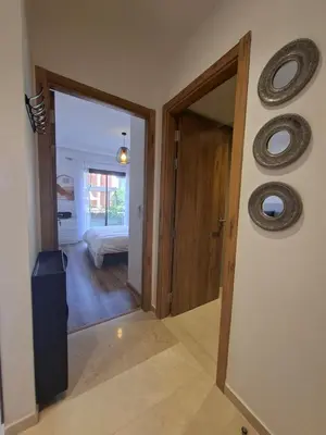 a hallway with a door leading to a bedroom at Noria Golf Marrakech Pool in Marrakech