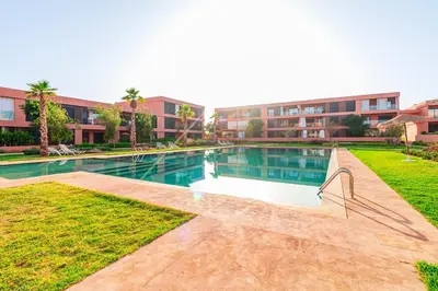 a swimming pool in front of a building at Noria Golf Marrakech Pool in Marrakech
