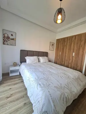a bedroom with a large bed with a white comforter at Noria Golf Marrakech Pool in Marrakech