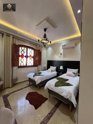 a bedroom with two beds and a window at Welcome to Riad Glam Marrakech in Marrakech