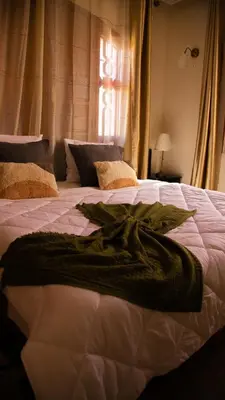 a bedroom with two beds and a window at Welcome to Riad Glam Marrakech in Marrakech