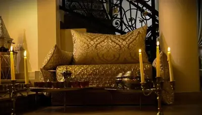 a living room with a couch and two candles at Welcome to Riad Glam Marrakech in Marrakech