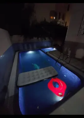 a computer keyboard and mouse sitting on a table in a pool at Welcome to Riad Glam Marrakech in Marrakech