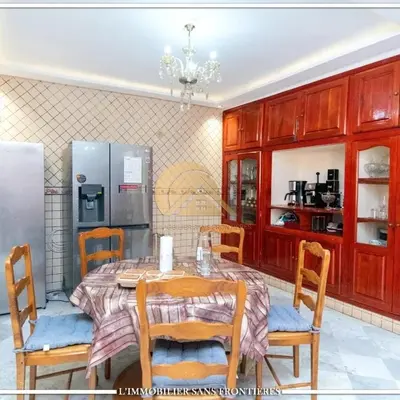 a kitchen with a table and chairs and a refrigerator at Welcome to Riad Glam Marrakech in Marrakech