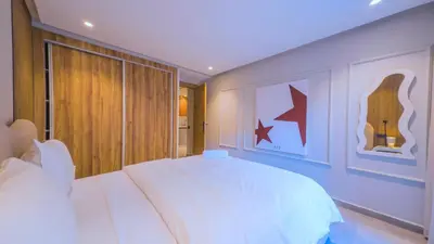 a bedroom with a white bed and a large window at MOZAIC26 I Terrasse & Piscine couverte I Hivernage in Marrakech