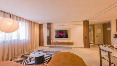 a living room with a tv and a couch at MOZAIC26 I Terrasse & Piscine couverte I Hivernage in Marrakech