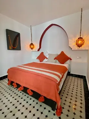 a bedroom with a large bed in a room at Riad Costa 2 privates pools rooftop breakfast in Marrakech