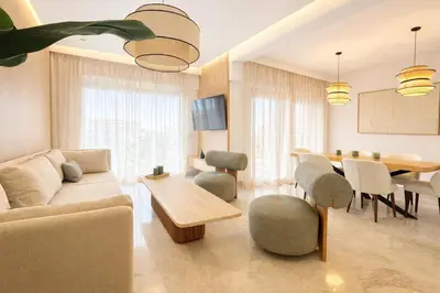 a living room with a couch and a table at Luxury 2 Bedroom Apartment Pool & Garden Wifi in Marrakech