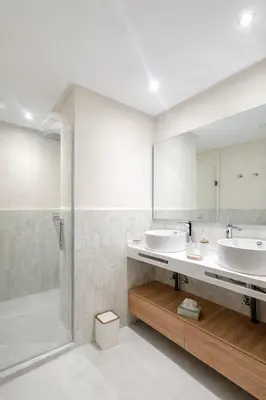 a bathroom with two sinks and a shower at Luxury 2 Bedroom Apartment Pool & Garden Wifi in Marrakech