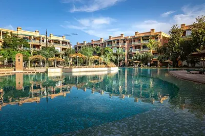a swimming pool in front of some apartment buildings at Appartement de charme avec piscine a Marrakech in Marrakech