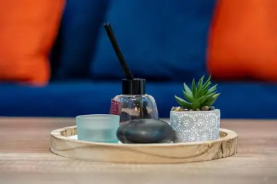 a wooden tray with a candle and a bottle on a table at Bright & Chic Stay in Marrakech Gueliz in Marrakech