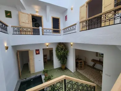 an overhead view of an apartment with a staircase and a plant at Riad Granada in Marrakech