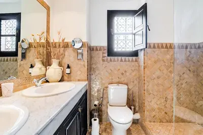 a bathroom with a toilet and a sink at Magnifique Villa EME, Golf Amelkis Marrakech - Piscine Chauffée in Marrakech