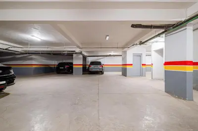 an empty parking garage with cars parked in it at 1BR Cosy 2 min M Avenue Parking, Piscine & Fibre in Marrakech