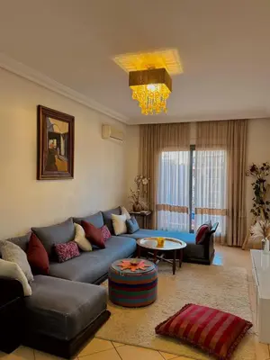a living room with a blue couch and a table at Cozy appartment - private terrace - Gueliz in Marrakech