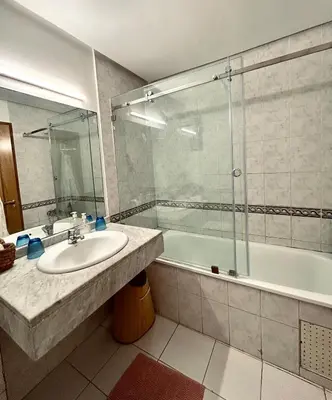 a bathroom with a sink and a shower and a tub at Cozy appartment - private terrace - Gueliz in Marrakech