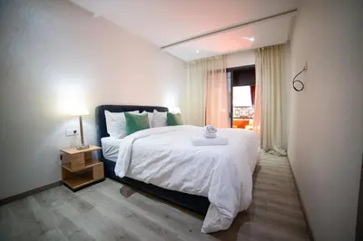 a bedroom with a large bed and a window at Les cristaux de Marrakech in Marrakech