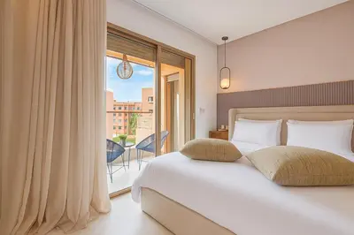 a bedroom with a bed and a large window at Studio moderne à louer au cœur de Gueliz Marrakech in Marrakech