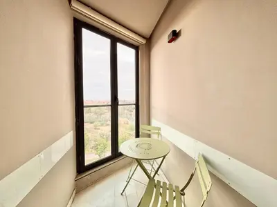 a table and two chairs in a room with a window at Verona Studio - 1 Bedroom Piscine & Rooftop in Marrakech
