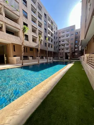 a swimming pool in the middle of a building at Studio a Menara garden in Marrakech