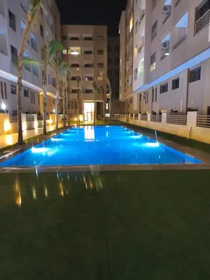 an empty swimming pool in a building at night at Studio a Menara garden in Marrakech