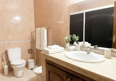 a bathroom with a sink and a toilet and a mirror at Appart Mobarak 5 in Marrakech