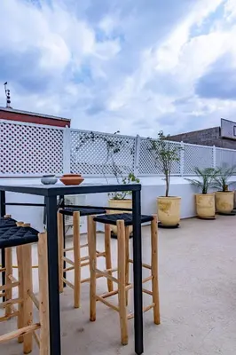 a table and chairs on top of a patio at Maison Meurisse Tlata private and Daily Breakfast in Marrakech
